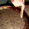 using a finger or spoon handle, make the groove